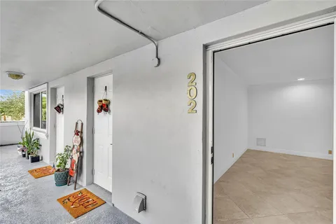 a view of an entryway with wooden floor and a potted plant
