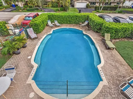 a view of a swimming pool and lounge chairs