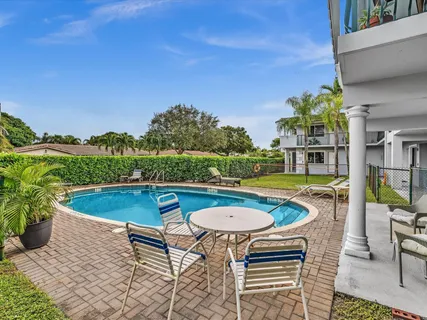 a view of a swimming pool with a lounge chairs