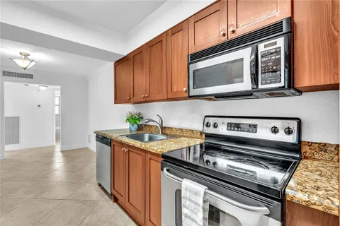 a kitchen with stainless steel appliances granite countertop a stove microwave and oven