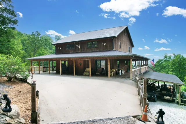 a view of a house with a patio and a yard
