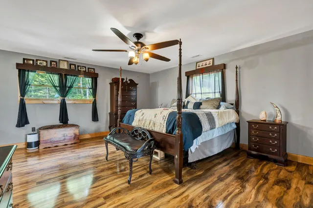 a bedroom with a bed window and a dresser