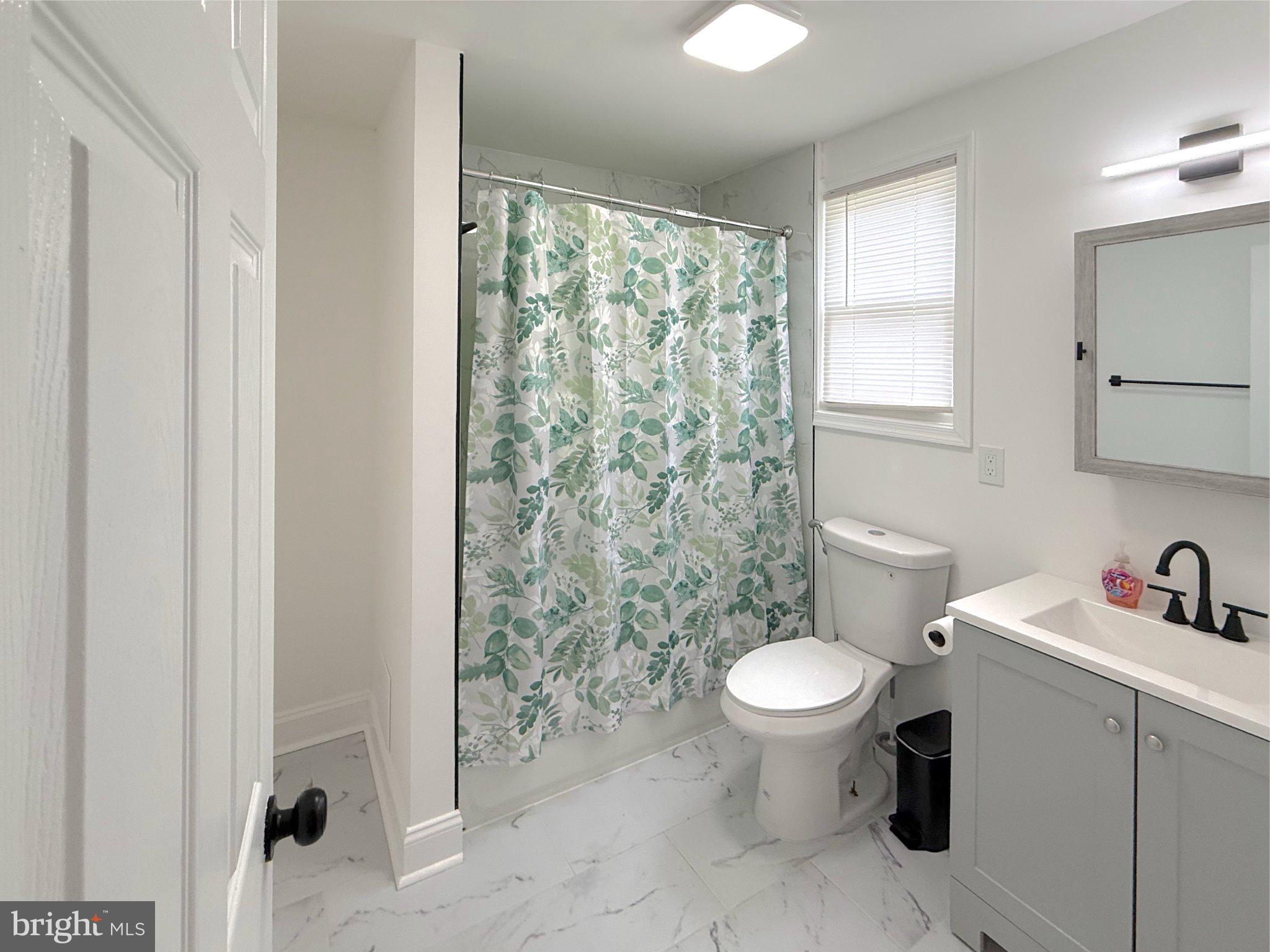 3703 6th Street, Unit 1 Baltimore, MD 21225 - Photo 11 of 12 Modern bathroom with serene decor.
