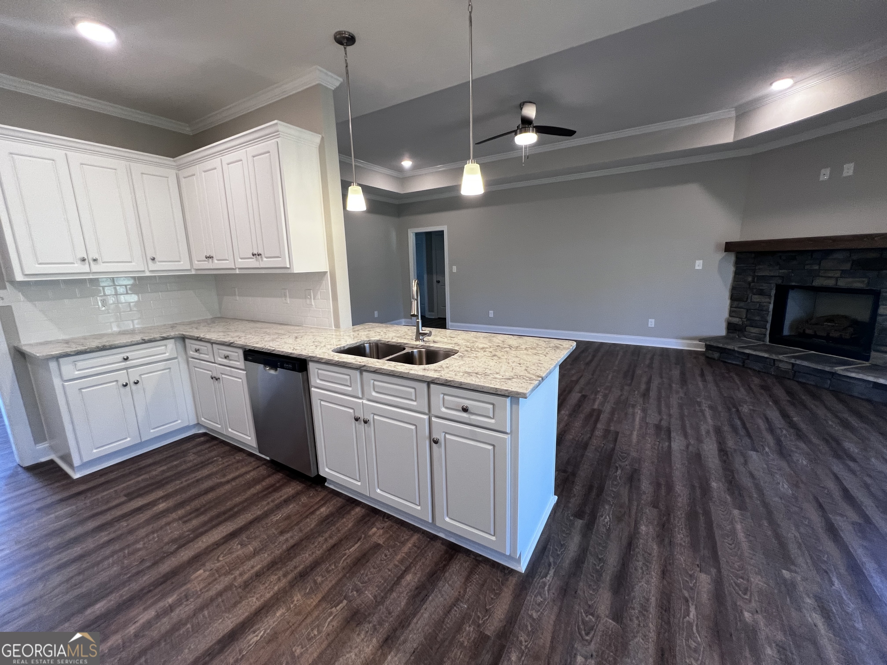 1045 Berkley Court Thomson, GA 30824 - Photo 11 of 32 a kitchen with a sink window and cabinets