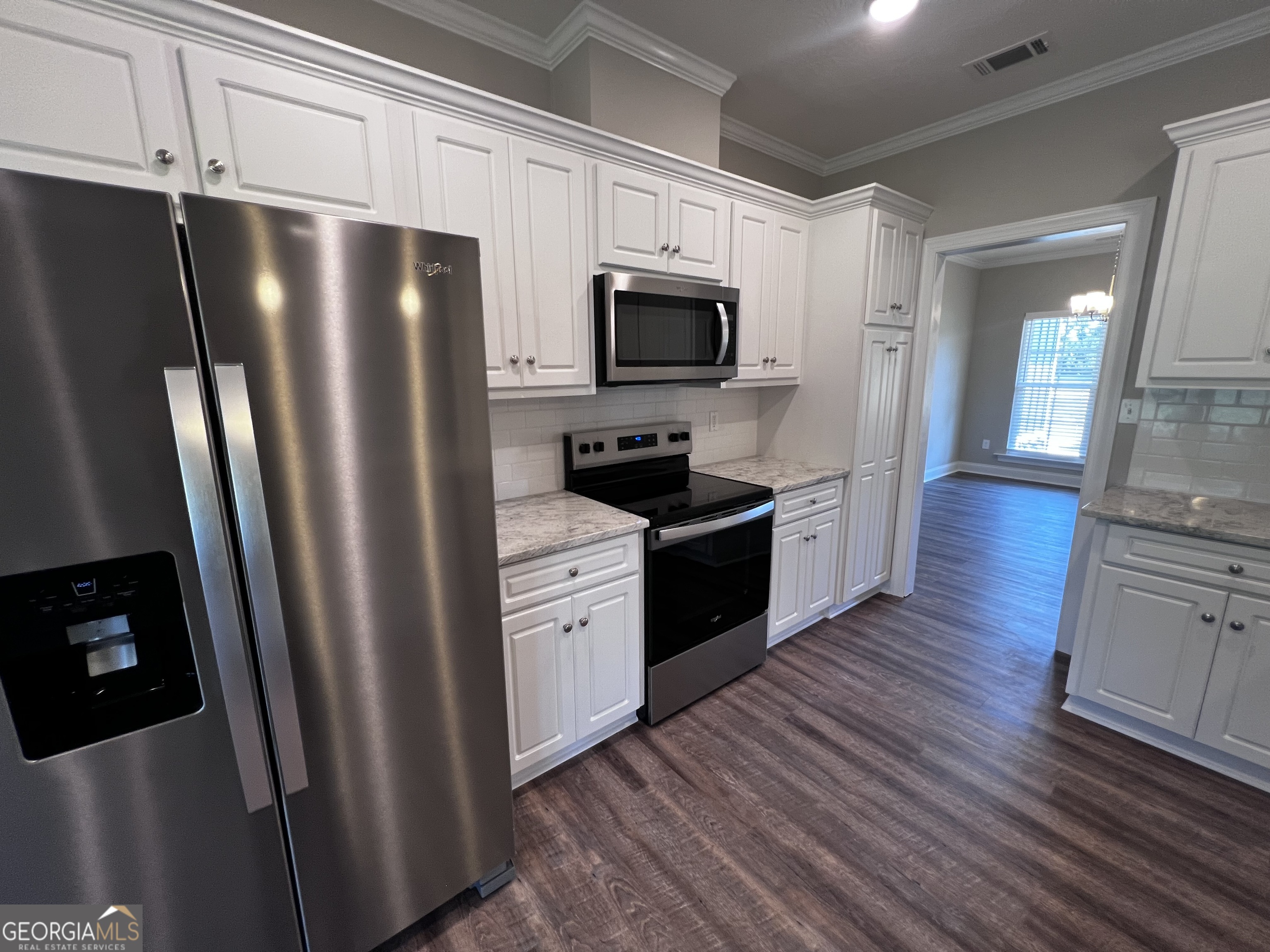 1045 Berkley Court Thomson, GA 30824 - Photo 12 of 32 a kitchen with stainless steel appliances a refrigerator microwave and sink