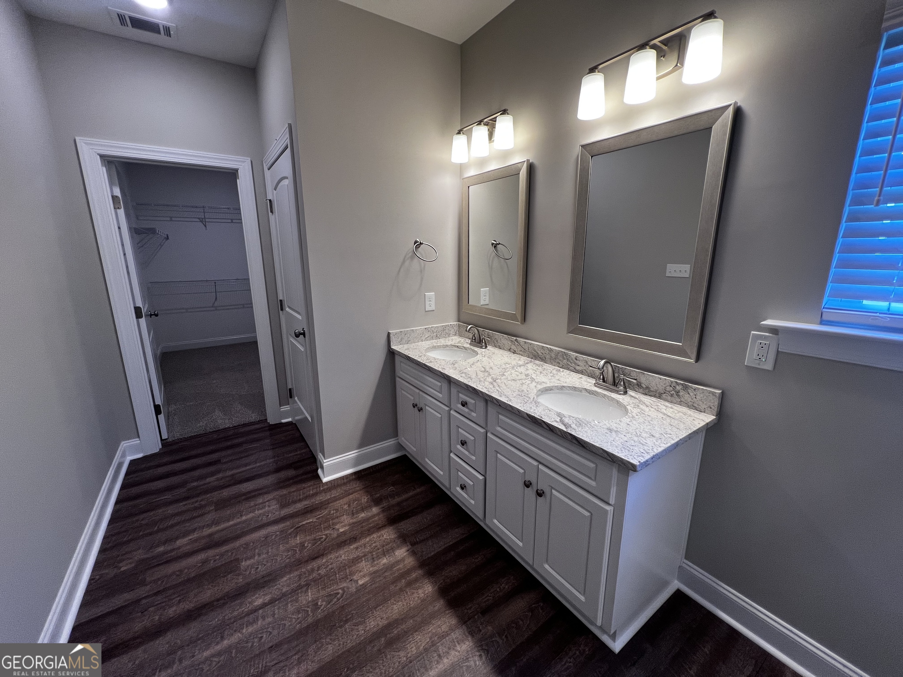 1045 Berkley Court Thomson, GA 30824 - Photo 19 of 32 a bathroom with a double vanity sink and a mirror