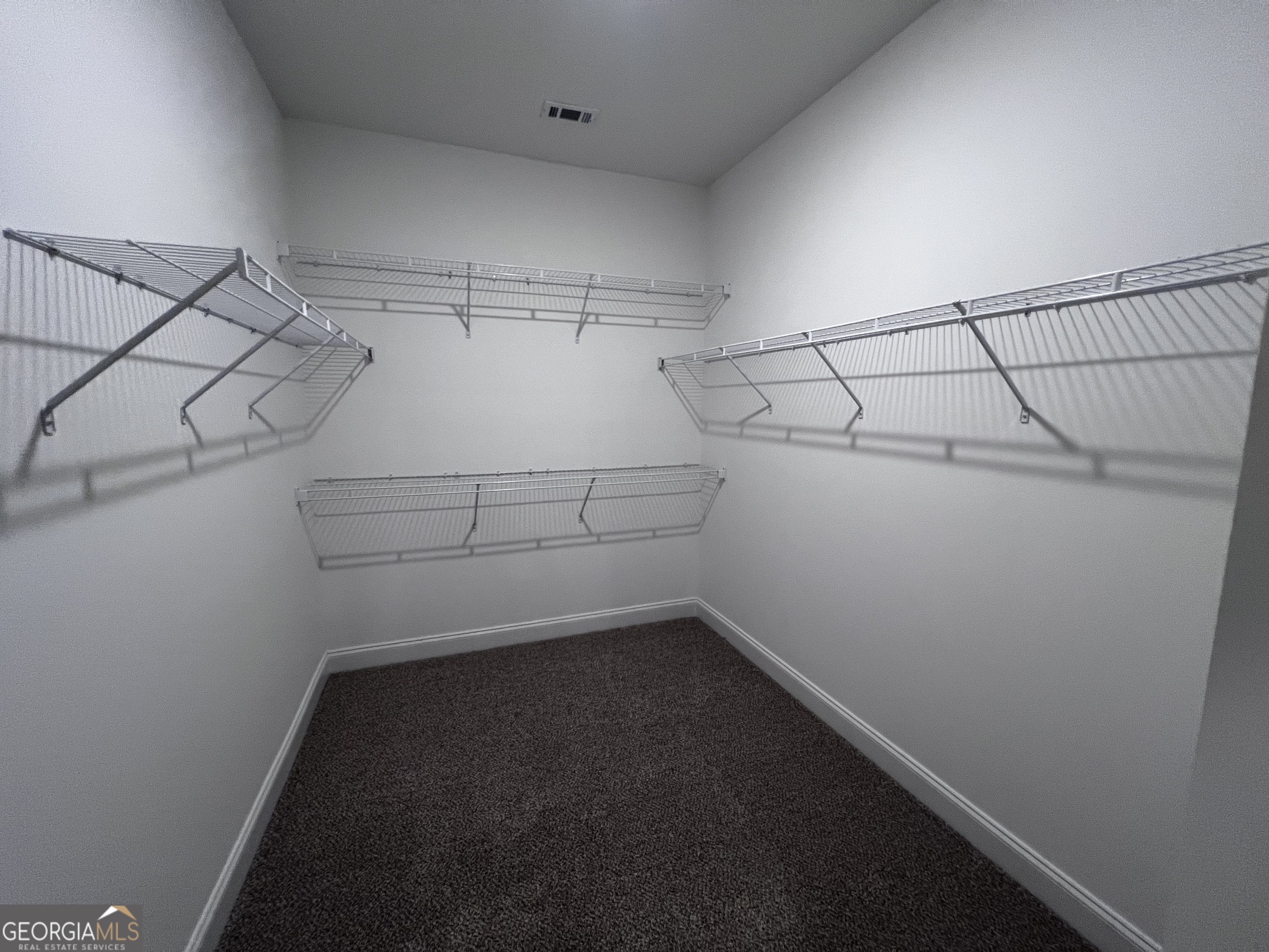 1045 Berkley Court Thomson, GA 30824 - Photo 20 of 32 a view of a room with racks on the wall
