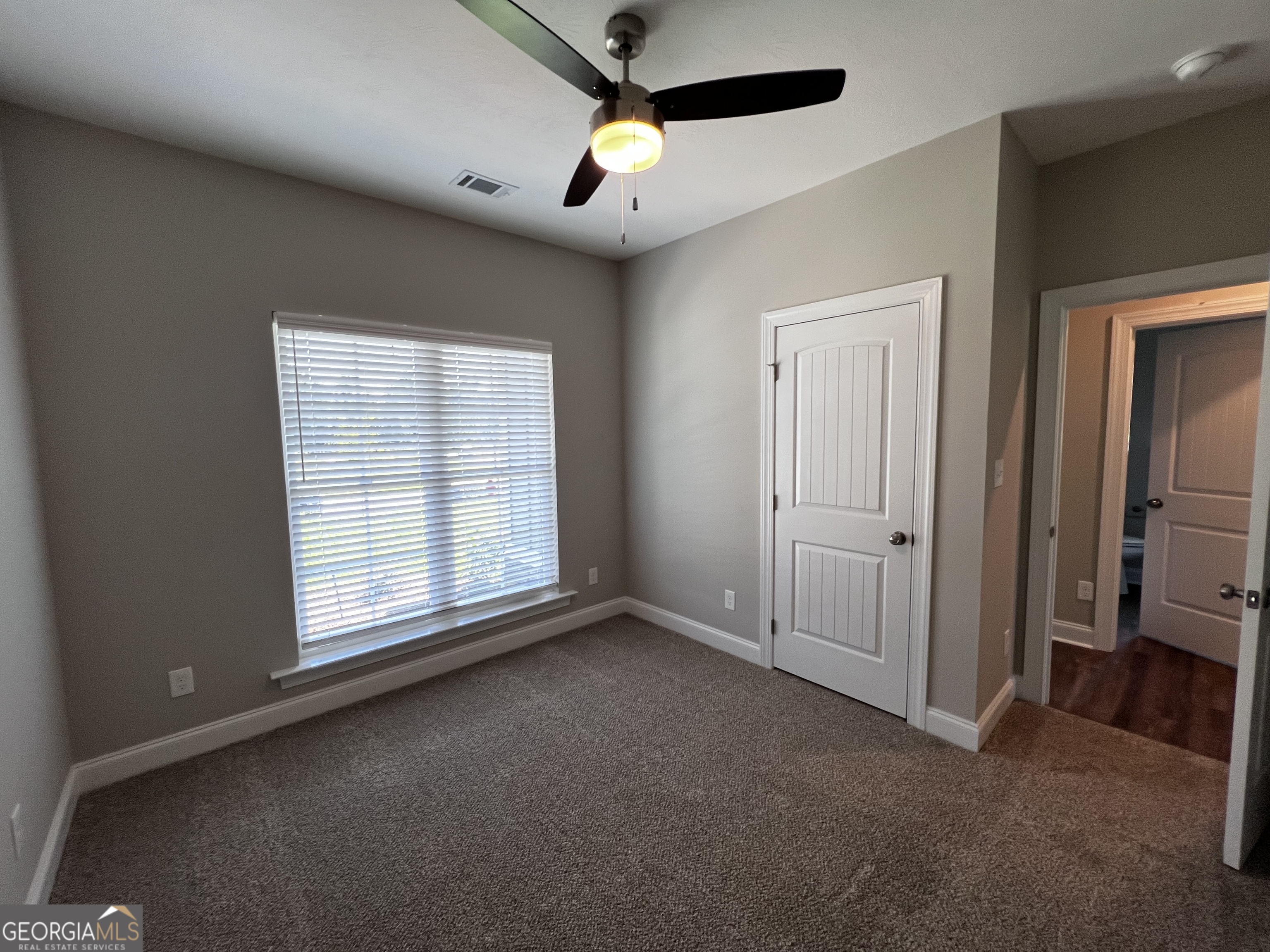 1045 Berkley Court Thomson, GA 30824 - Photo 26 of 32 an empty room with ceiling fan and windows