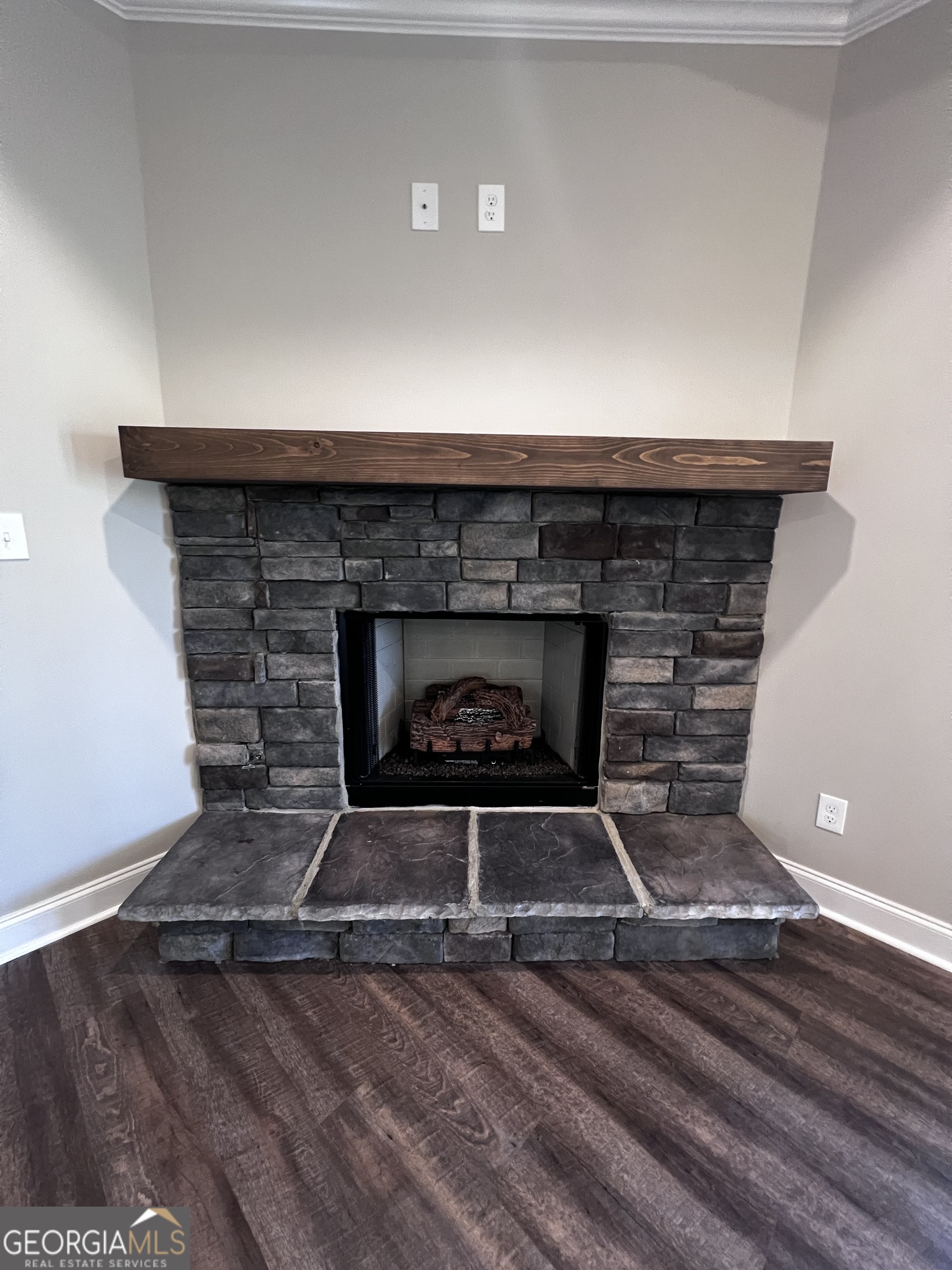 1045 Berkley Court Thomson, GA 30824 - Photo 6 of 32 a fireplace with a wooden floor