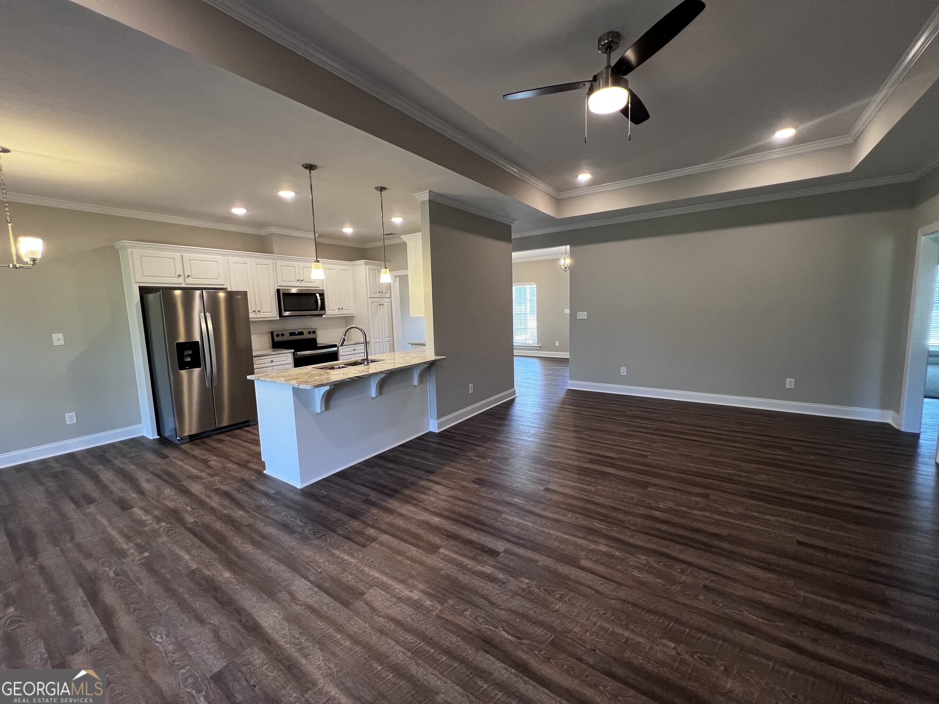 1045 Berkley Court Thomson, GA 30824 - Photo 7 of 32 a view of kitchen with cabinets counter top stainless steel appliances and wooden floor