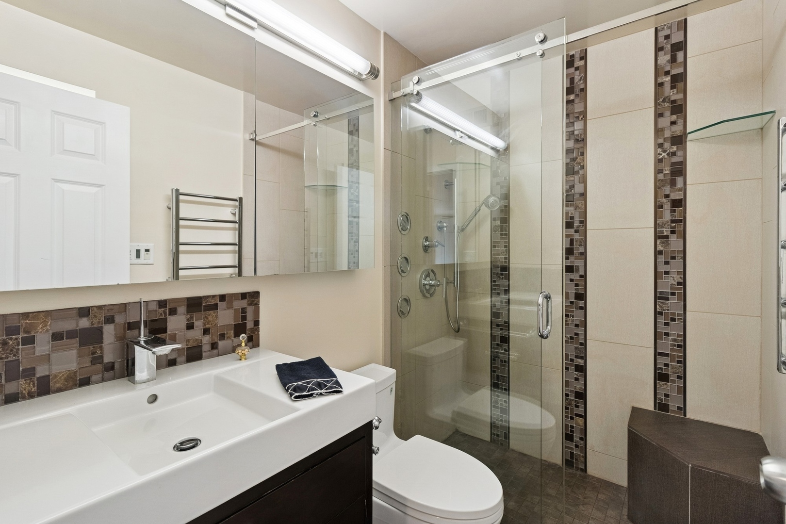 71 East Division Street, Unit 702 Chicago, IL 60611 - Photo 11 of 18 a bathroom with a sink mirror toilet and shower