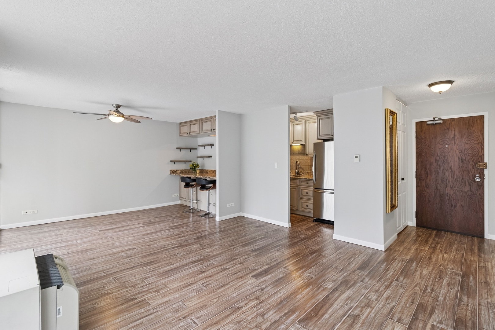 71 East Division Street, Unit 702 Chicago, IL 60611 - Photo 3 of 18 a view of empty room with wooden floor