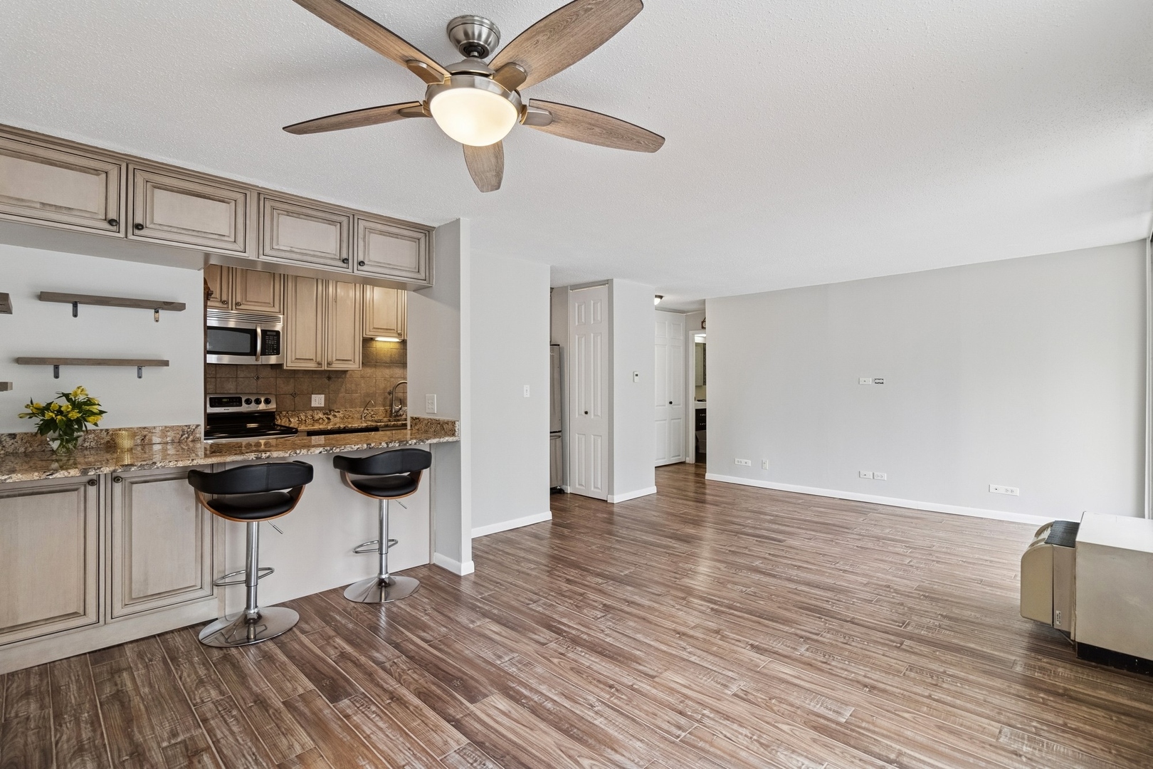 71 East Division Street, Unit 702 Chicago, IL 60611 - Photo 4 of 18 a view of a kitchen with wooden floor and a kitchen