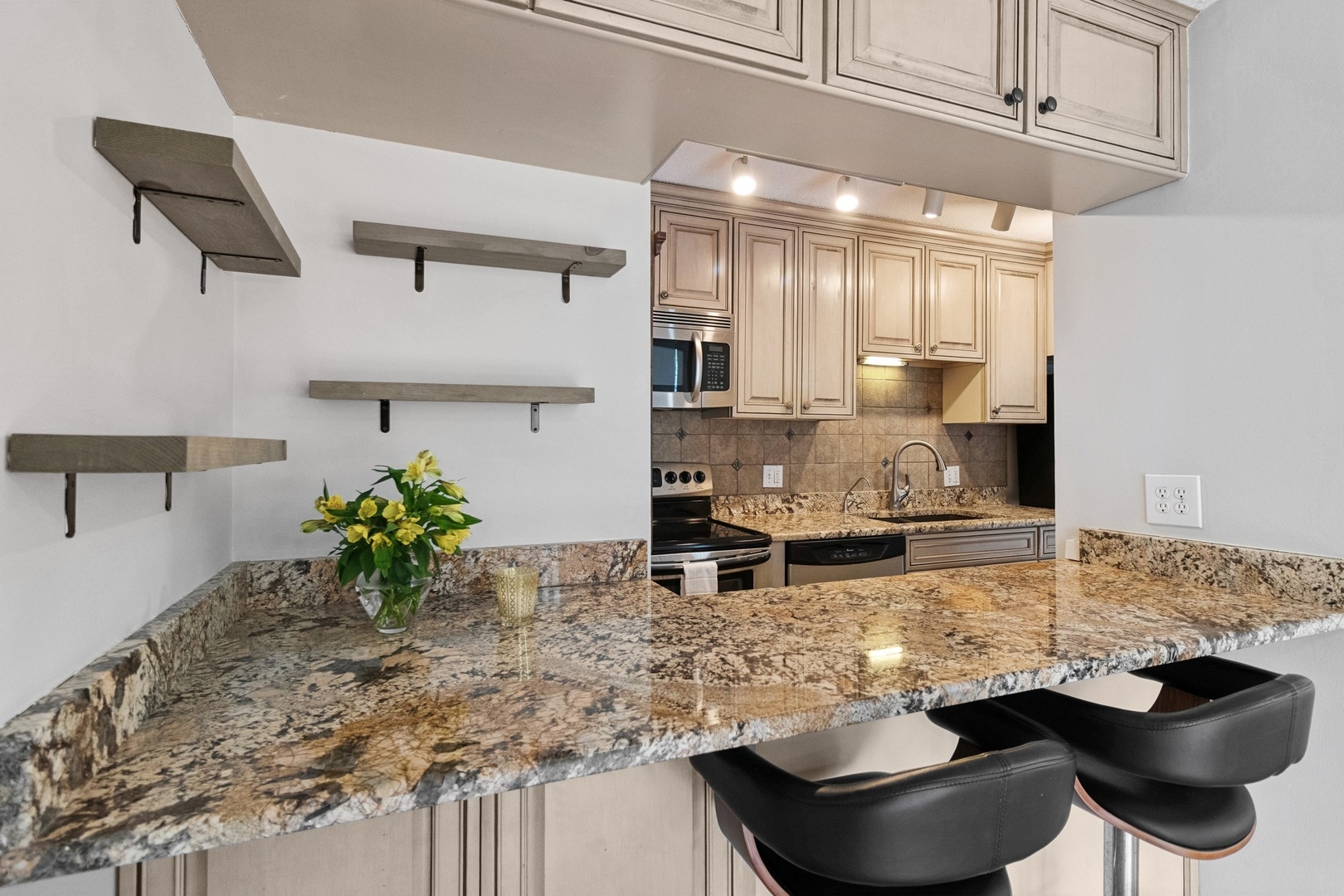 71 East Division Street, Unit 702 Chicago, IL 60611 - Photo 5 of 18 a kitchen with stainless steel appliances granite countertop a sink a stove and a wooden floors