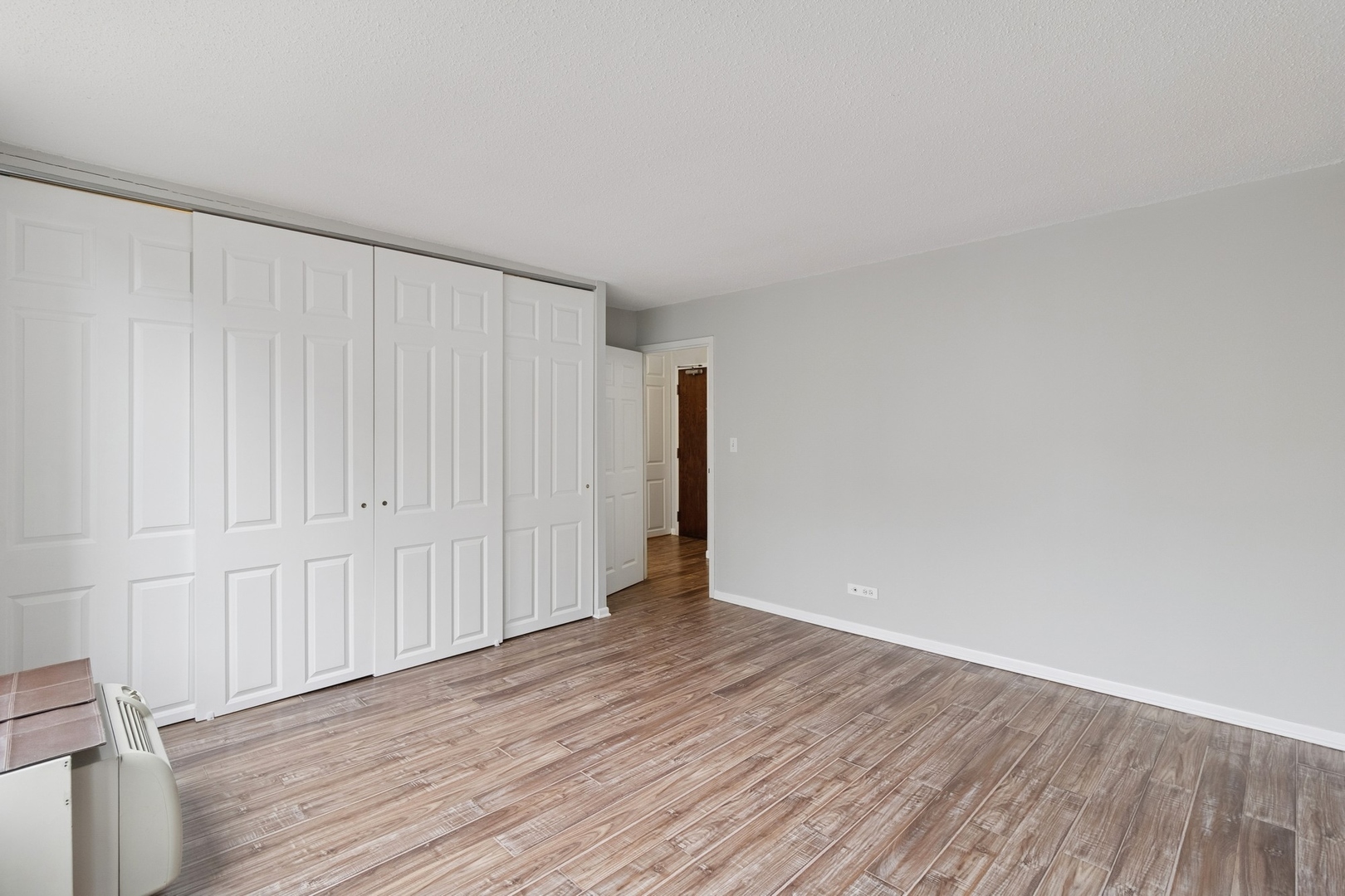 71 East Division Street, Unit 702 Chicago, IL 60611 - Photo 10 of 18 a view of an empty room with wooden floor