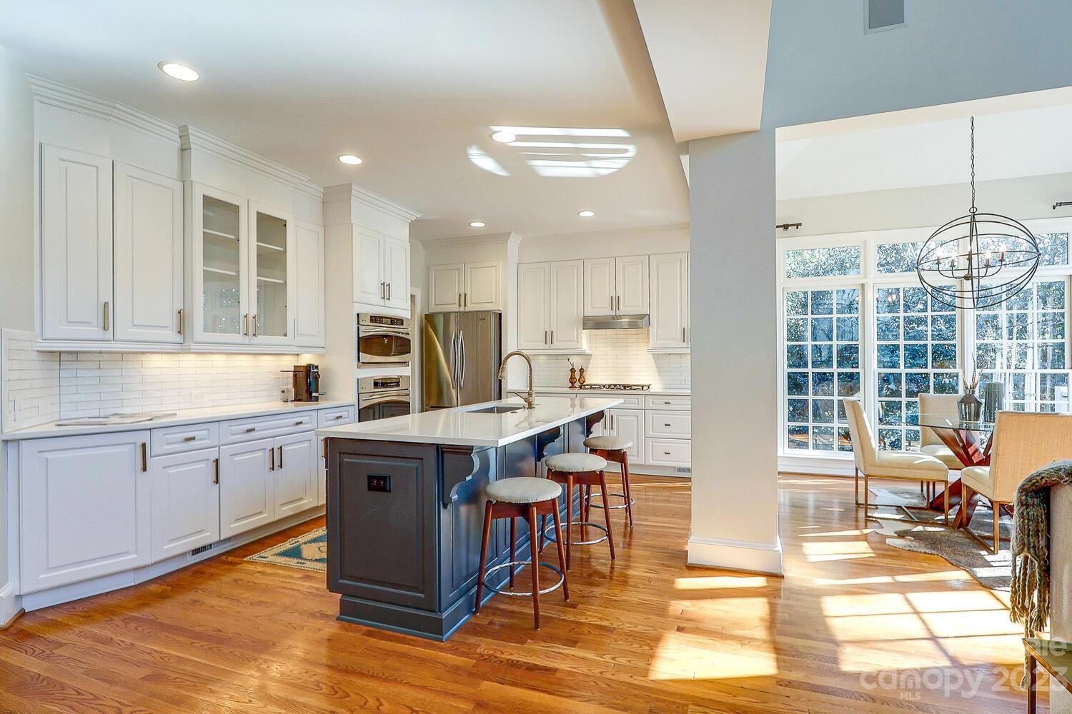 1732 Rutledge Avenue Charlotte, NC 28211 - Photo 11 of 30 a kitchen with stainless steel appliances granite countertop a stove top oven a sink dishwasher and cabinets with wooden floor