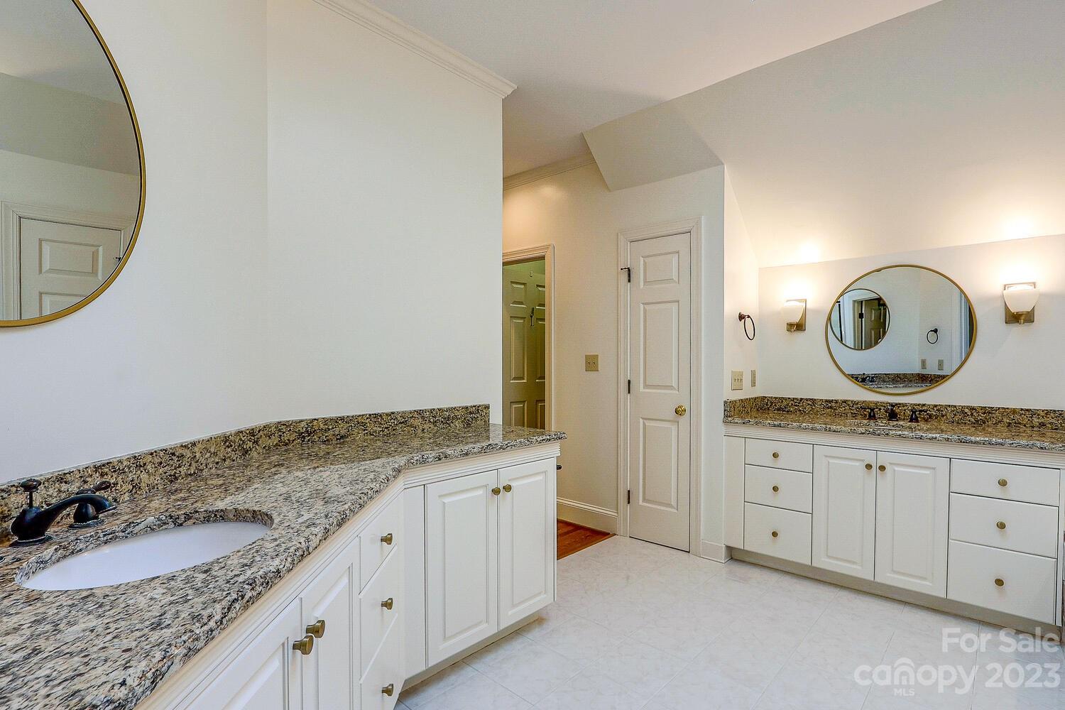 1732 Rutledge Avenue Charlotte, NC 28211 - Photo 21 of 30 a spacious bathroom with a granite countertop sink and a mirror