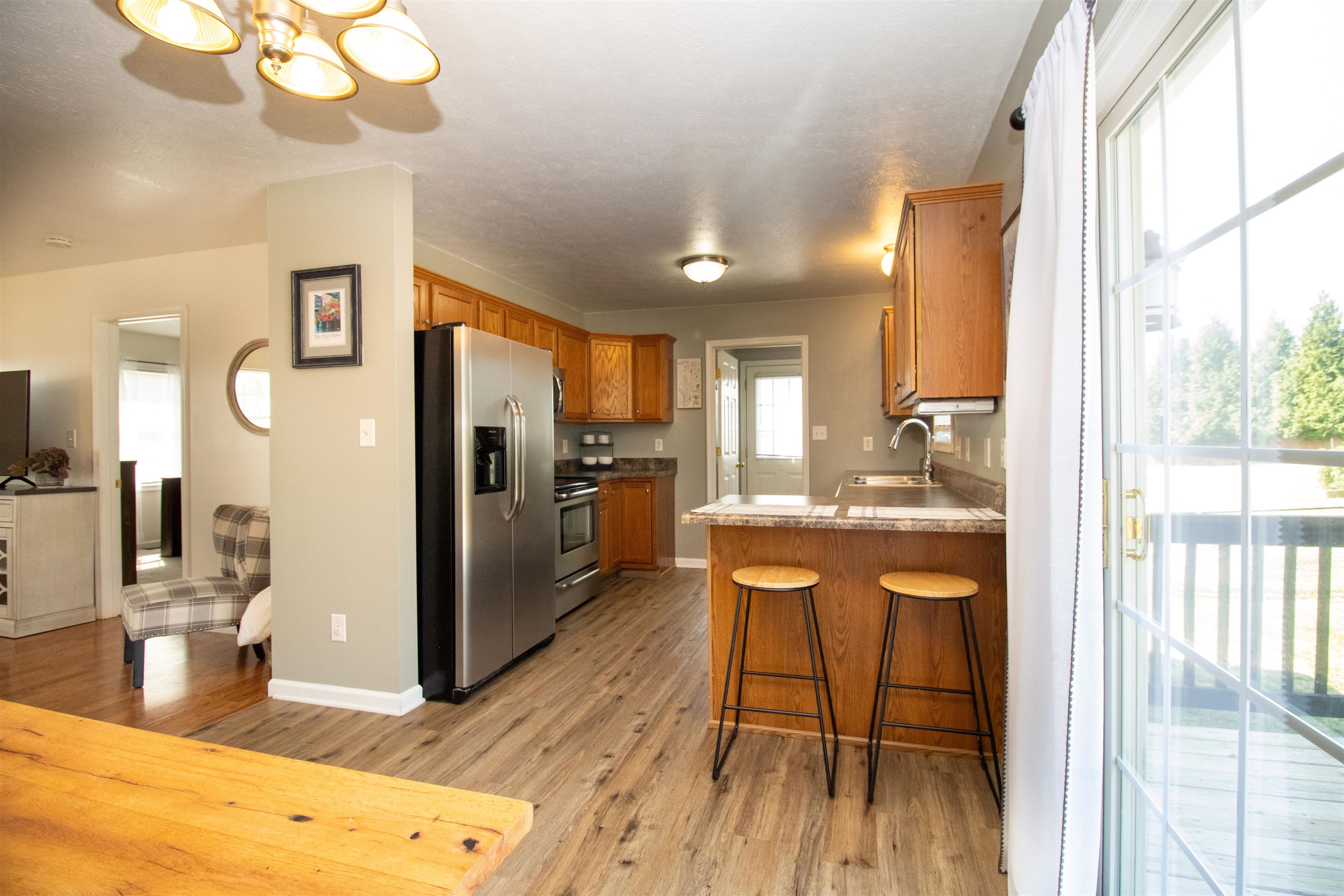 37 Danforth Drive Weyers Cave, VA 24486 - Photo 13 of 45 a kitchen with stainless steel appliances granite countertop a refrigerator a sink dishwasher a stove and a dining table with wooden floor