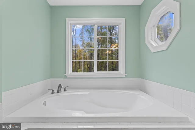 a white bath tub sitting next to a window