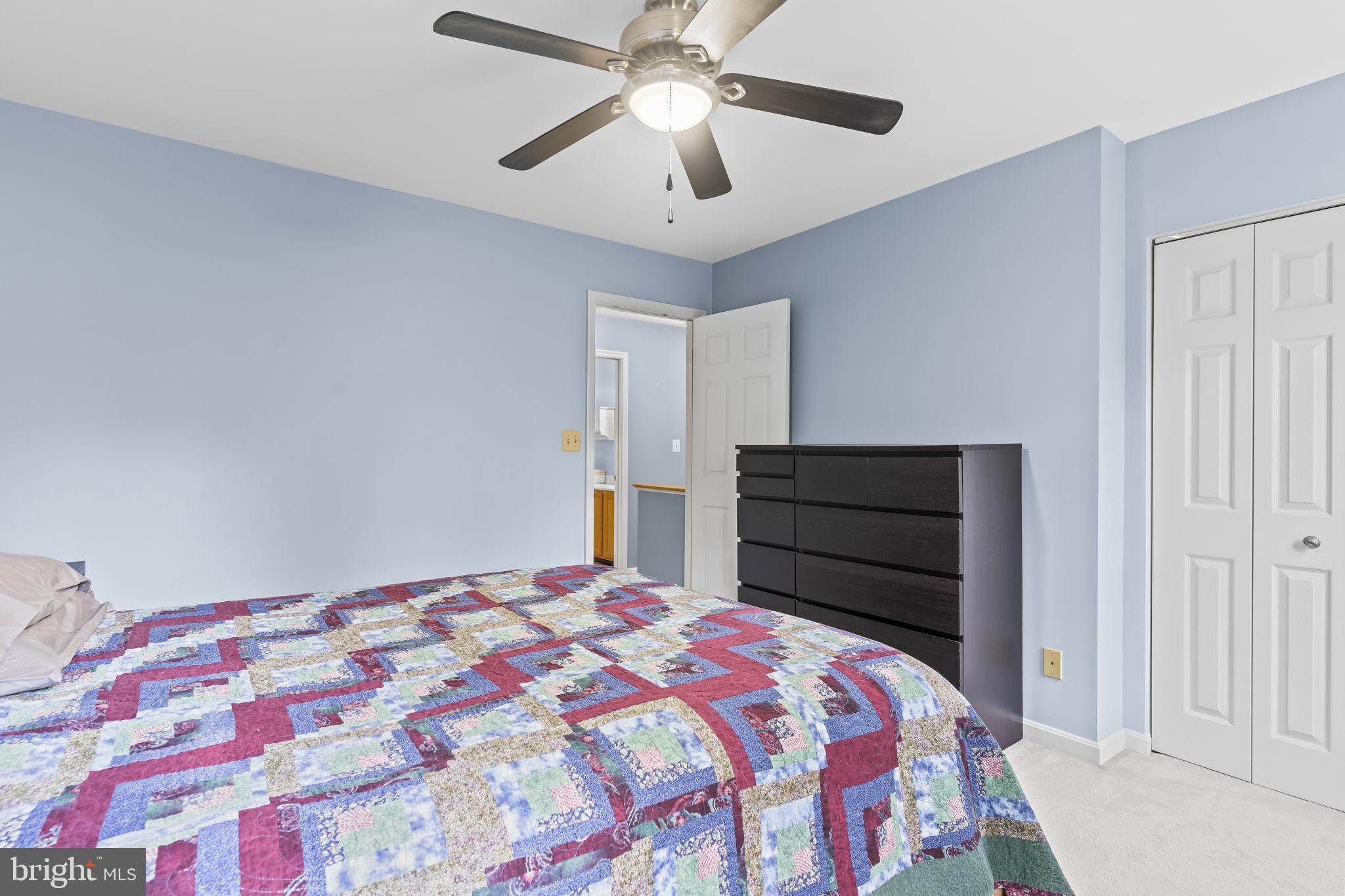 1425 Abbey Lane Huntingtown, MD 20639 - Photo 30 of 42 a bedroom with a bed and a chandelier