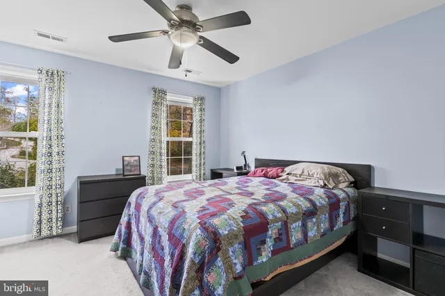 a bedroom with a bed dresser and a window