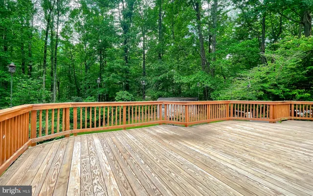 a view of balcony with wooden floor and fence