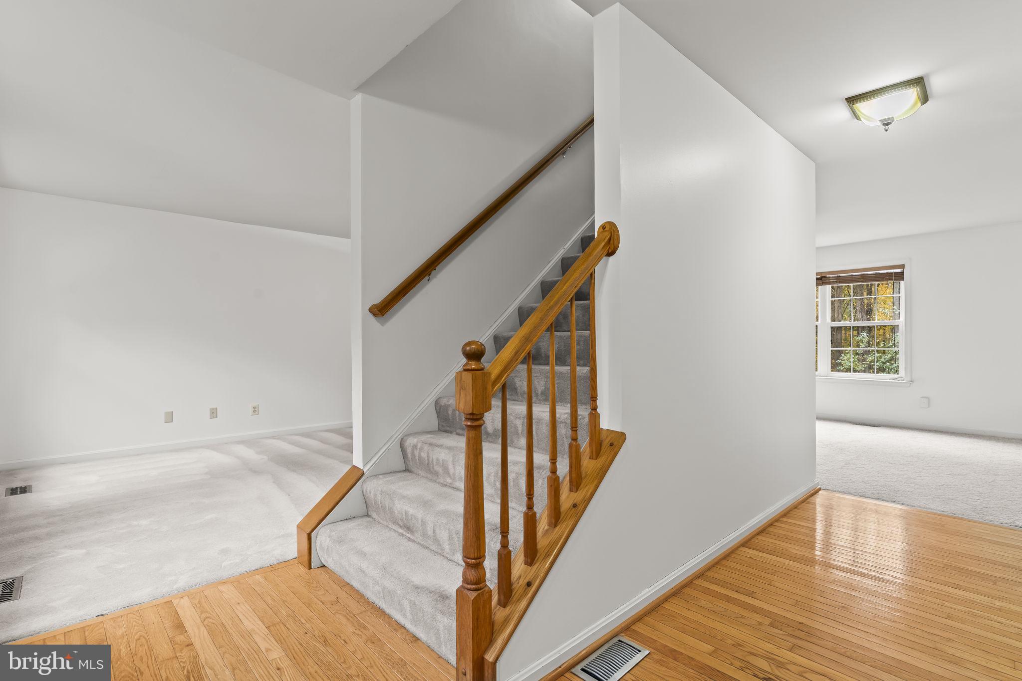 1425 Abbey Lane Huntingtown, MD 20639 - Photo 8 of 42 a view of a livingroom with wooden floor and stairs