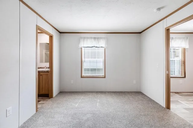 an empty room with windows and closet