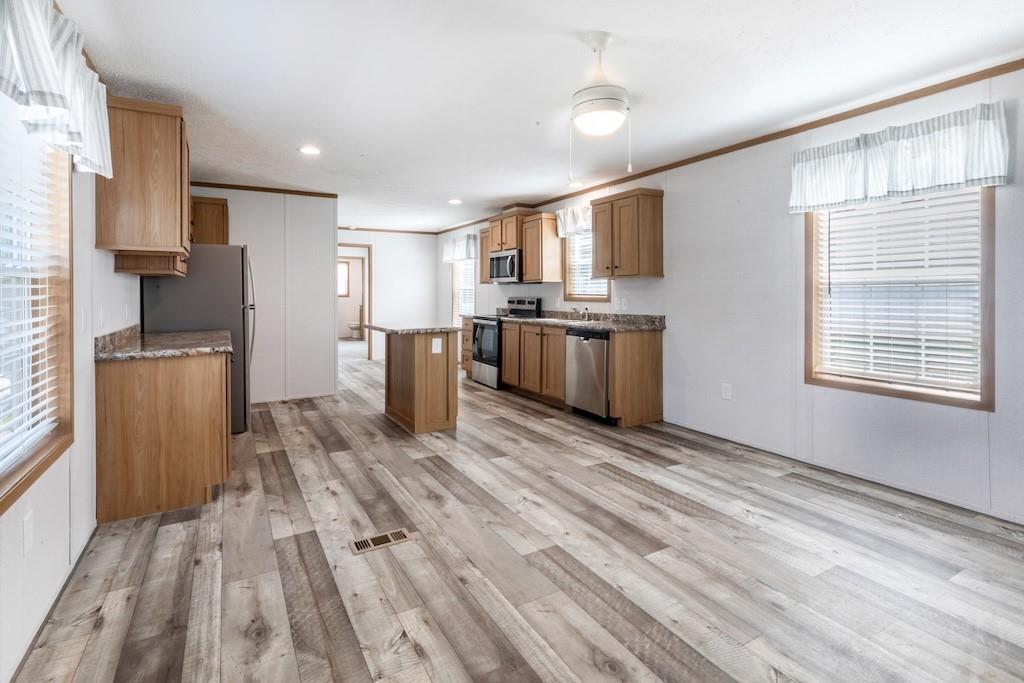 321 Beallsville Road Bentleyville, PA 15314 - Photo 6 of 21 a large kitchen with stainless steel appliances kitchen island granite countertop a refrigerator stove oven a sink dishwasher and white cabinets with wooden floor