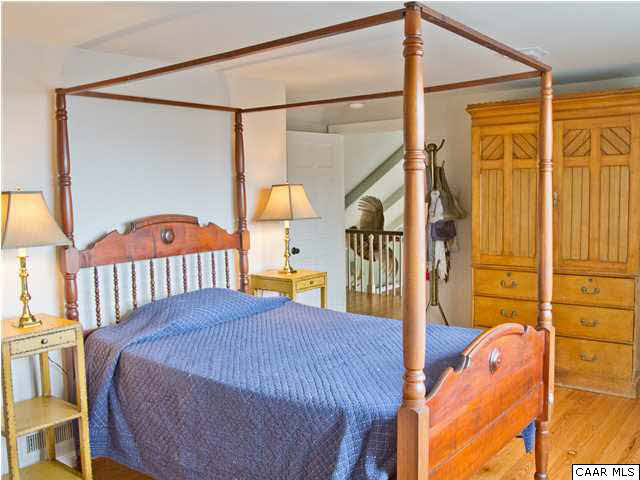 1190 Turner Mountain Road Charlottesville, VA 22901 - Photo 19 of 44 a bedroom with a bed and a lamp on the table