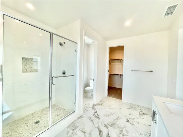 a bathroom with a double vanity sink a mirror and a shower