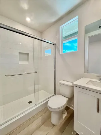 a bathroom with a toilet sink and shower