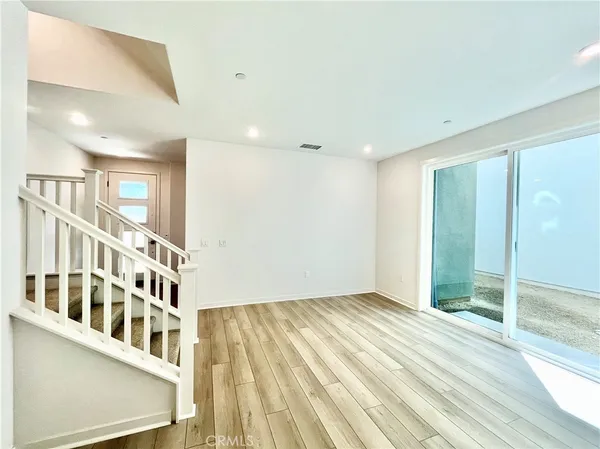 a view of a room with wooden floor and a window