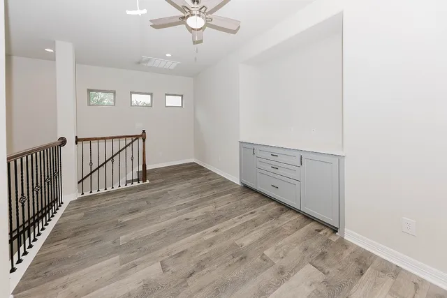 a view of a hallway with wooden floor and interior of the house