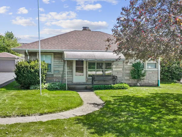 a view of a house with a yard and plants