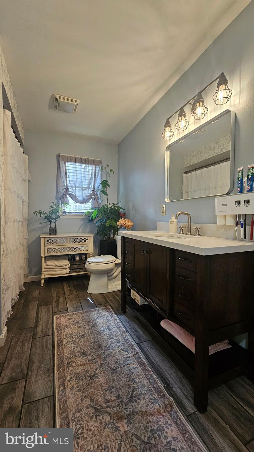 64 Dubois Road Bridgeton, NJ 08302 - Photo 11 of 31 a bathroom with a sink and a mirror