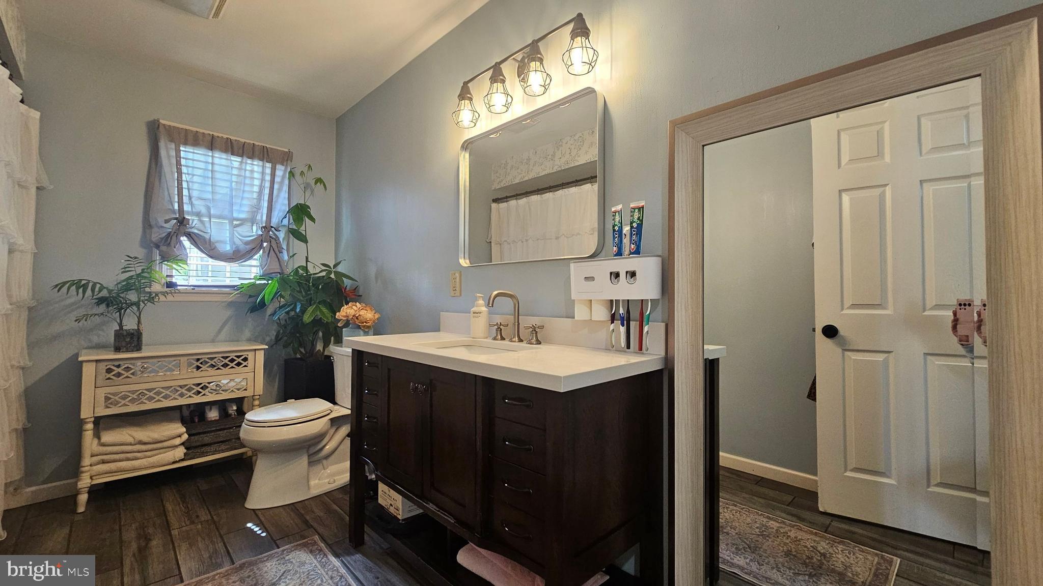 64 Dubois Road Bridgeton, NJ 08302 - Photo 12 of 31 a bathroom with a sink a toilet and a mirror