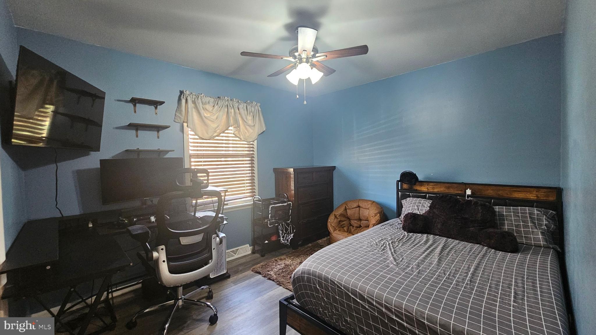 64 Dubois Road Bridgeton, NJ 08302 - Photo 16 of 31 a bedroom with a bed and a flat tv screen on the dresser