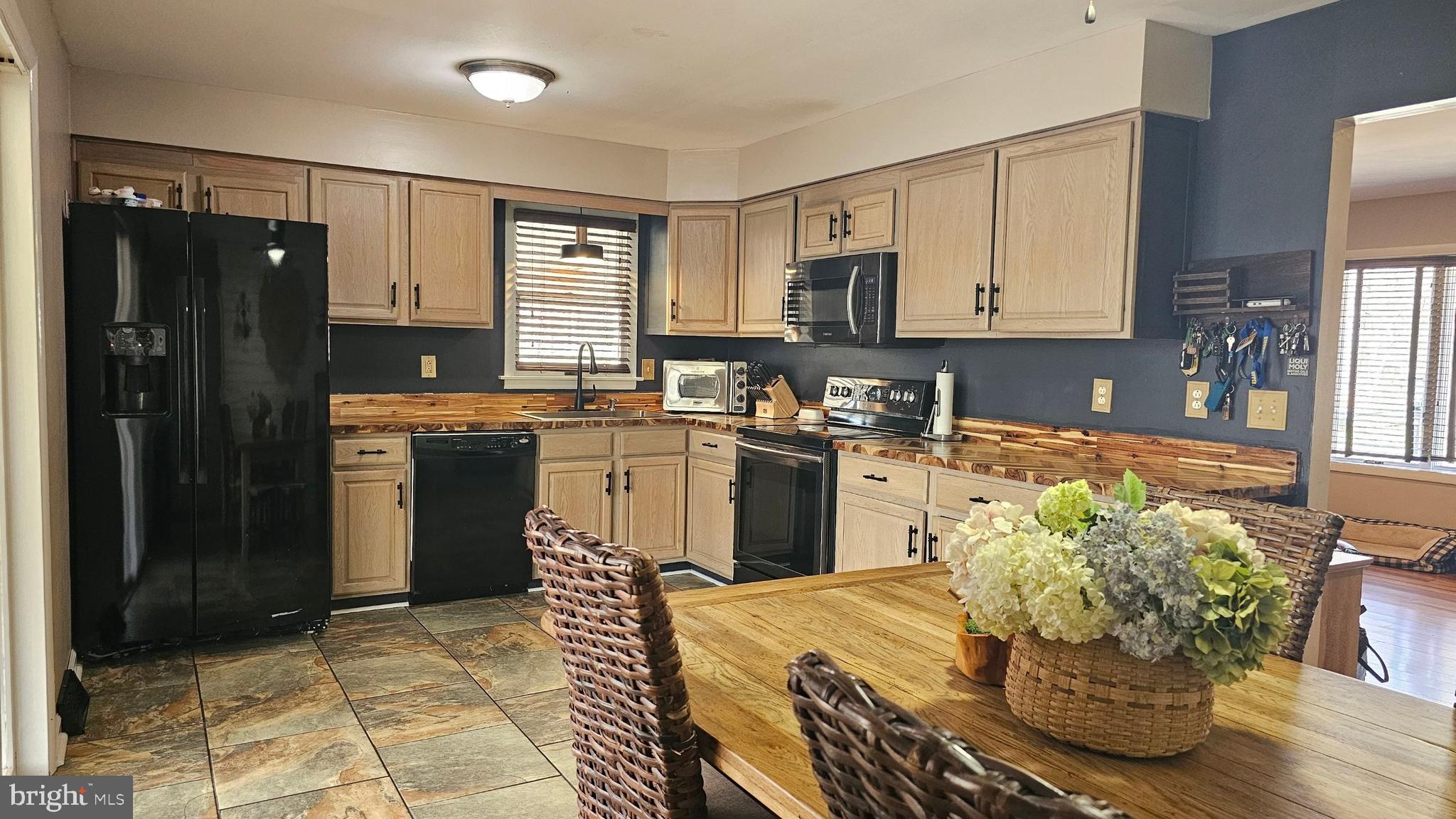 64 Dubois Road Bridgeton, NJ 08302 - Photo 6 of 31 a kitchen with stainless steel appliances granite countertop a refrigerator a stove a sink dishwasher and white cabinets with wooden floor