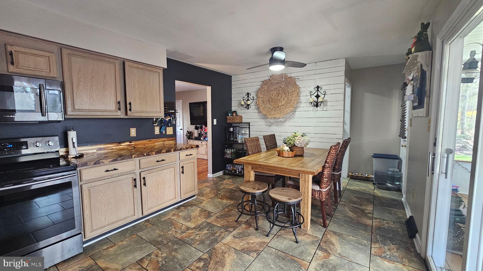 64 Dubois Road Bridgeton, NJ 08302 - Photo 8 of 31 a kitchen with a dining table chairs and white cabinets