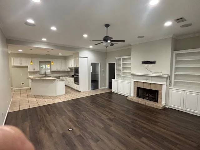 a view of a kitchen with cabinets and wooden floor