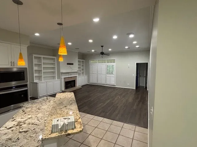 a view of a kitchen with microwave and refrigerator