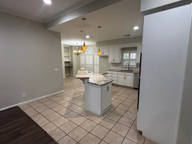 a kitchen with a sink and cabinets