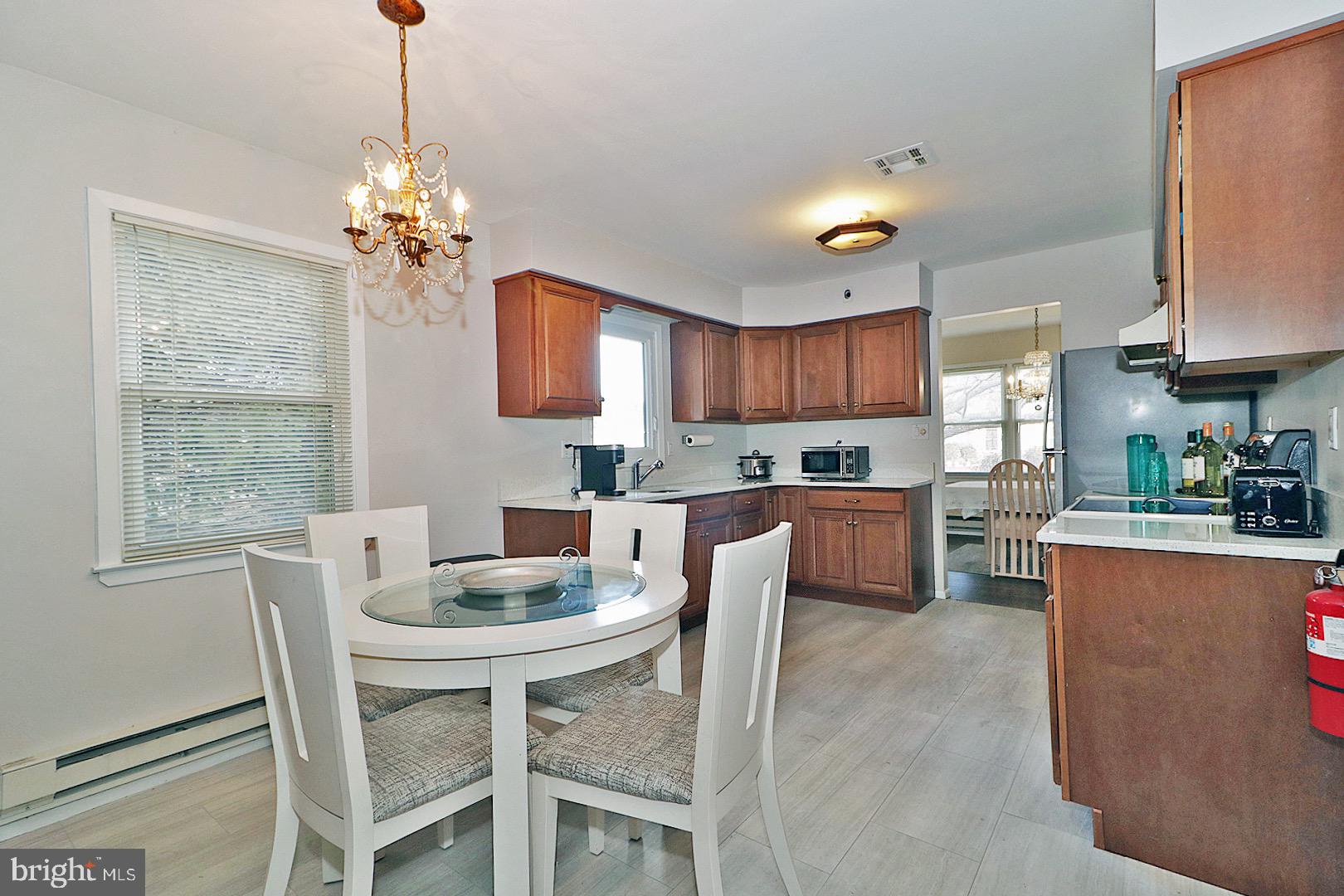 23 Abbey Road Brick, NJ 08723 - Photo 11 of 37 a view of a dining room with furniture a chandelier and wooden floor
