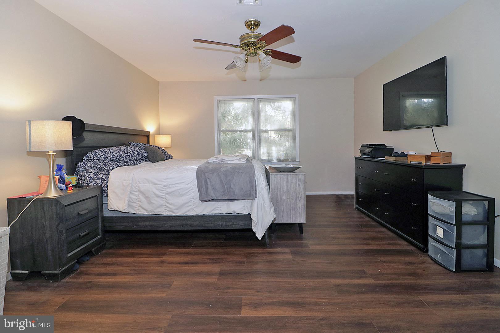 23 Abbey Road Brick, NJ 08723 - Photo 14 of 37 a bedroom with a bed and a flat screen tv