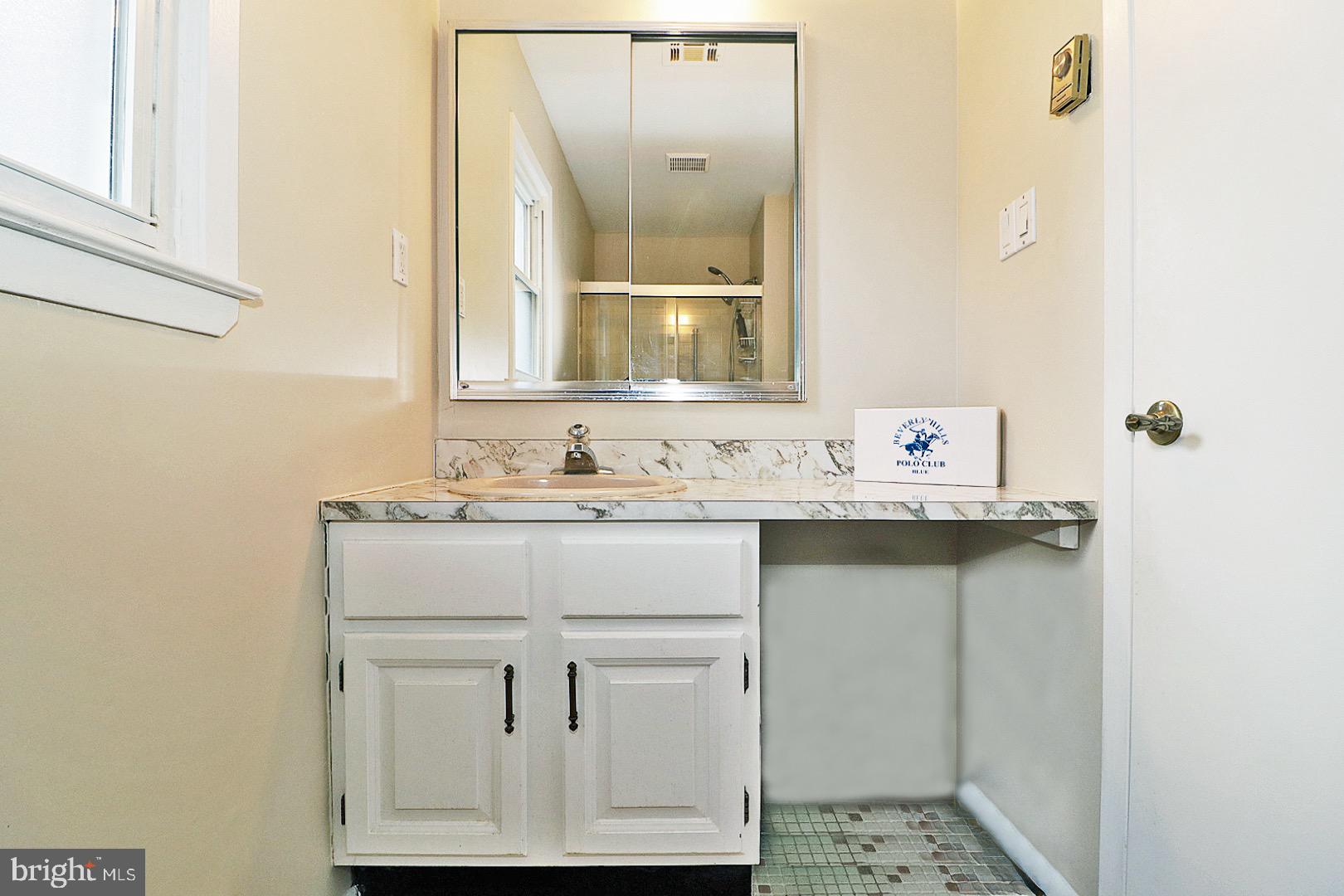 23 Abbey Road Brick, NJ 08723 - Photo 16 of 37 a bathroom with a sink and a mirror