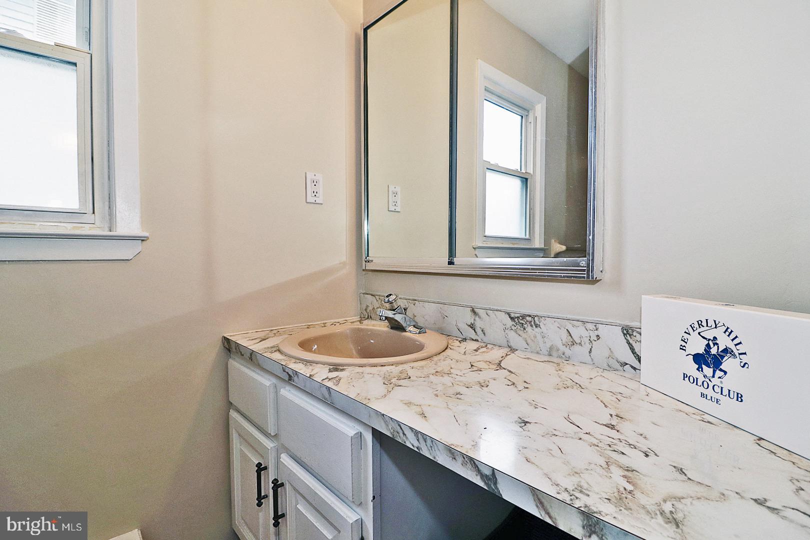 23 Abbey Road Brick, NJ 08723 - Photo 19 of 37 a bathroom with a granite countertop sink and a mirror