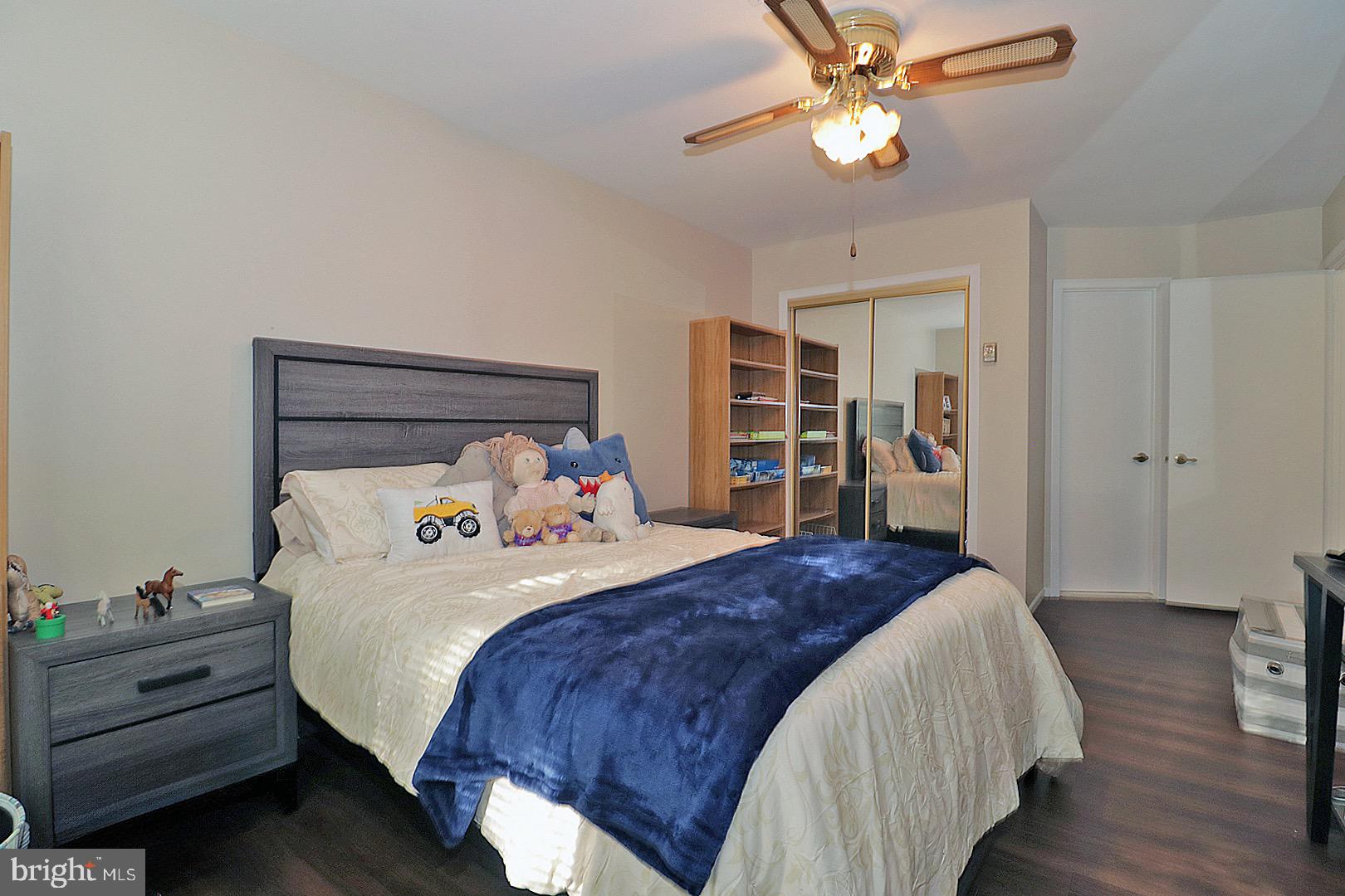 23 Abbey Road Brick, NJ 08723 - Photo 22 of 37 a bedroom with bed and a chandelier