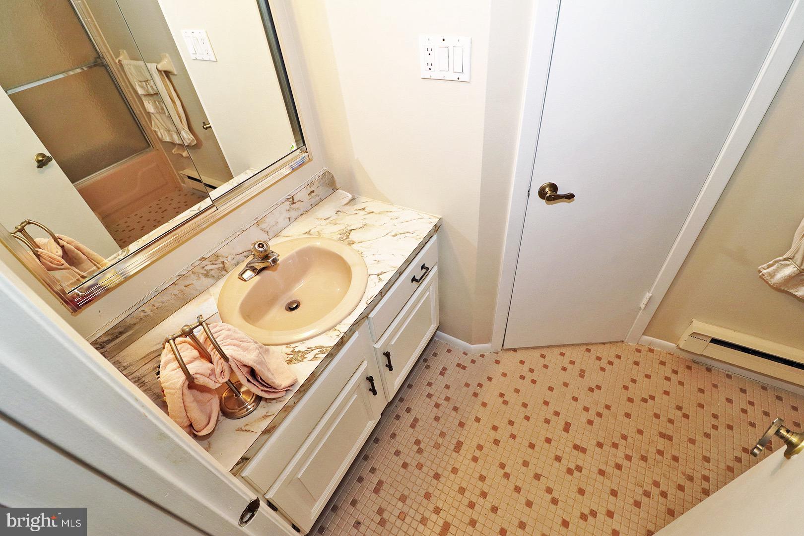 23 Abbey Road Brick, NJ 08723 - Photo 25 of 37 a bathroom with a sink a mirror and shower