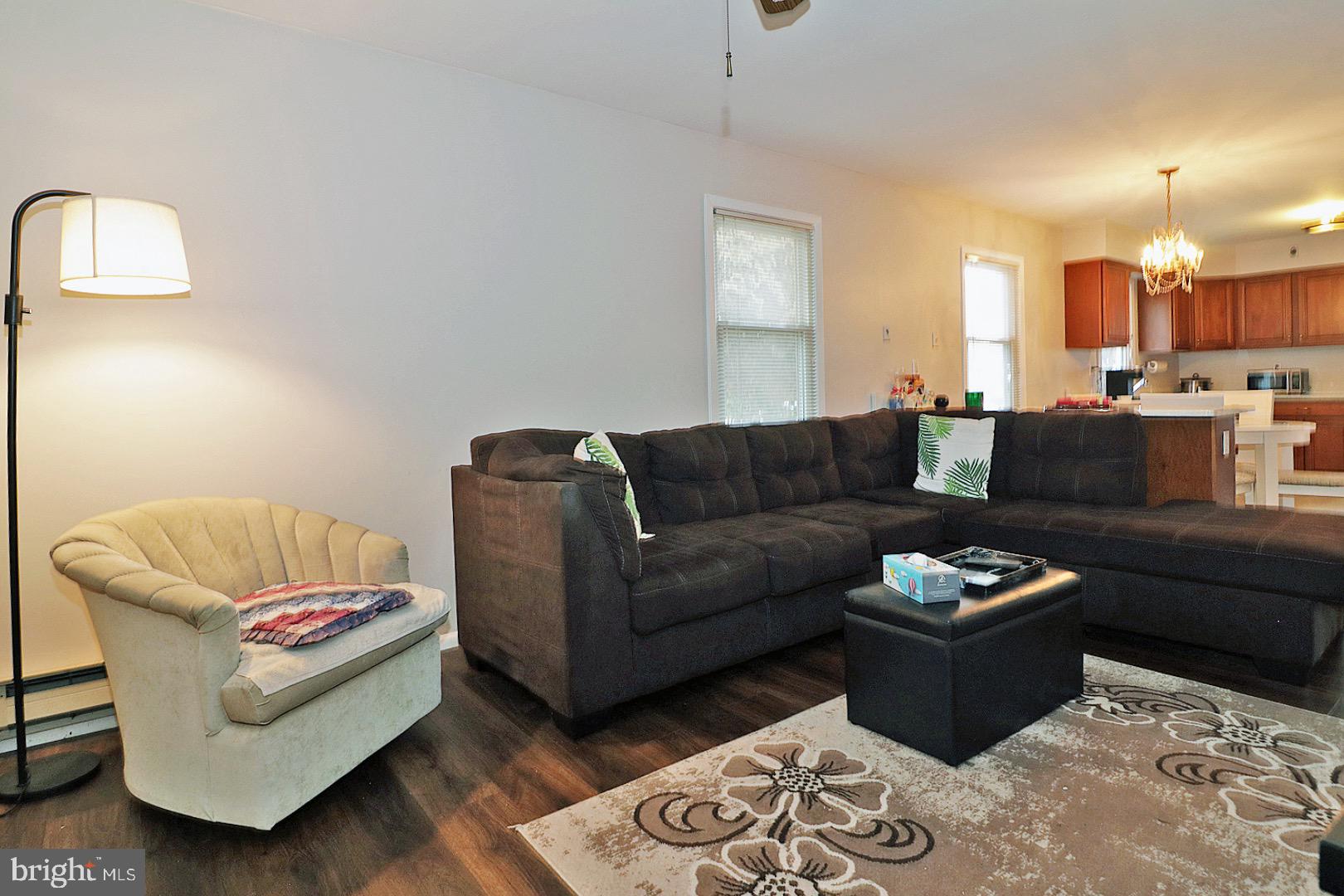 23 Abbey Road Brick, NJ 08723 - Photo 27 of 37 a living room with furniture a rug and a lamp